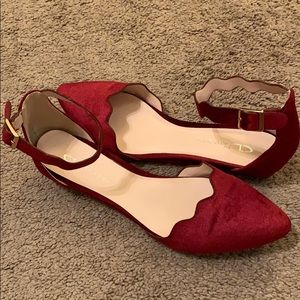 Burgundy velvet flats with strap.